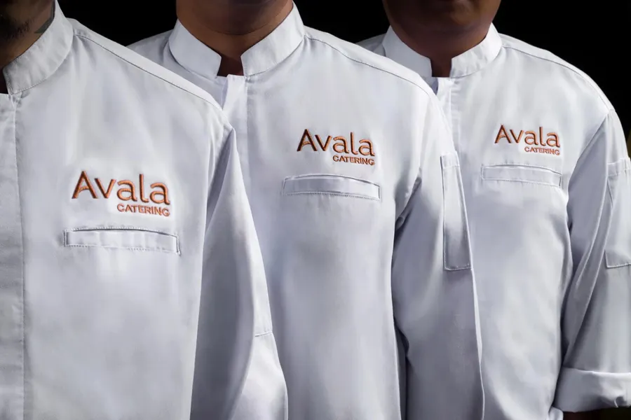Avala Catering chefs in branded white uniforms.