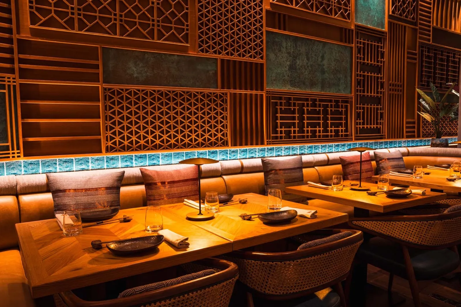 Dining room with carved lattice walls in warm light.