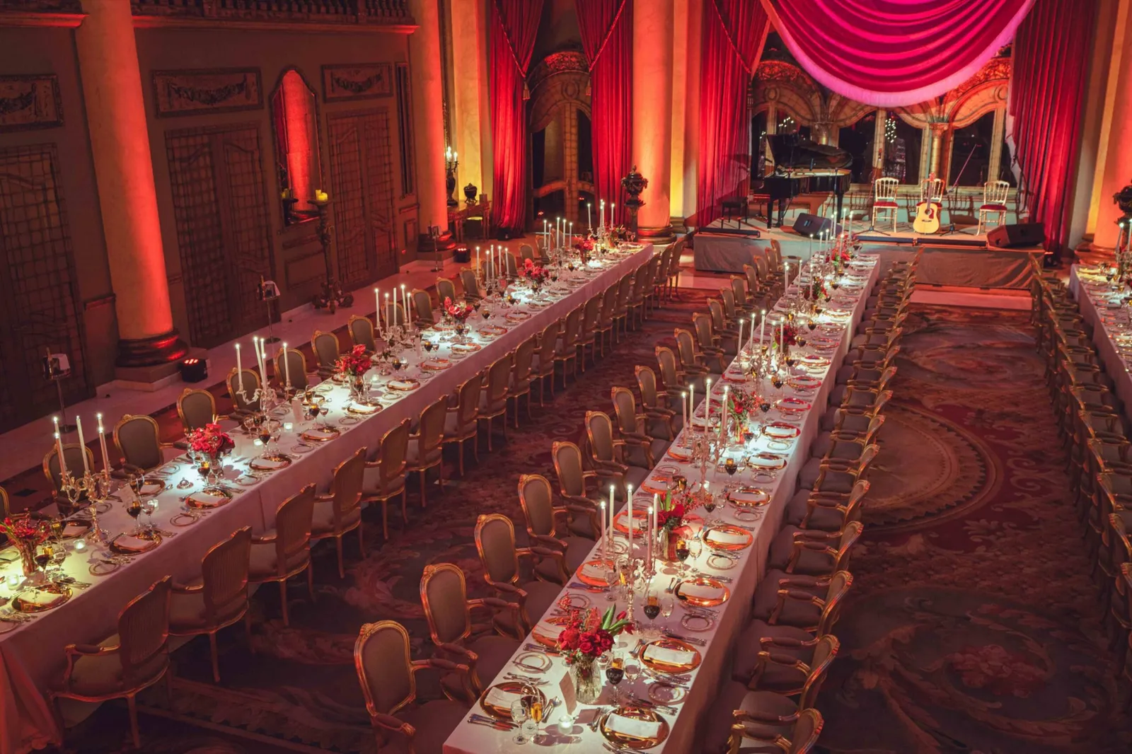 Long banquet table dressed in red for a celebration.