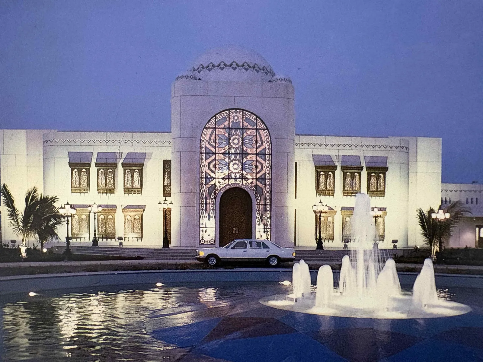 Palace venue with fountains at dusk.