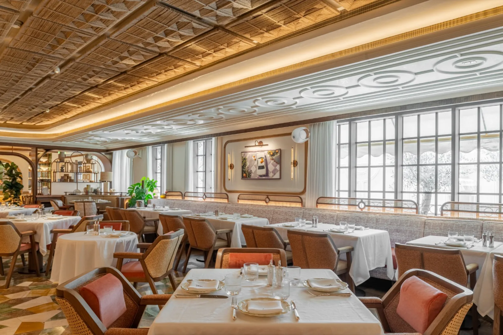 Long dining room with tall windows.